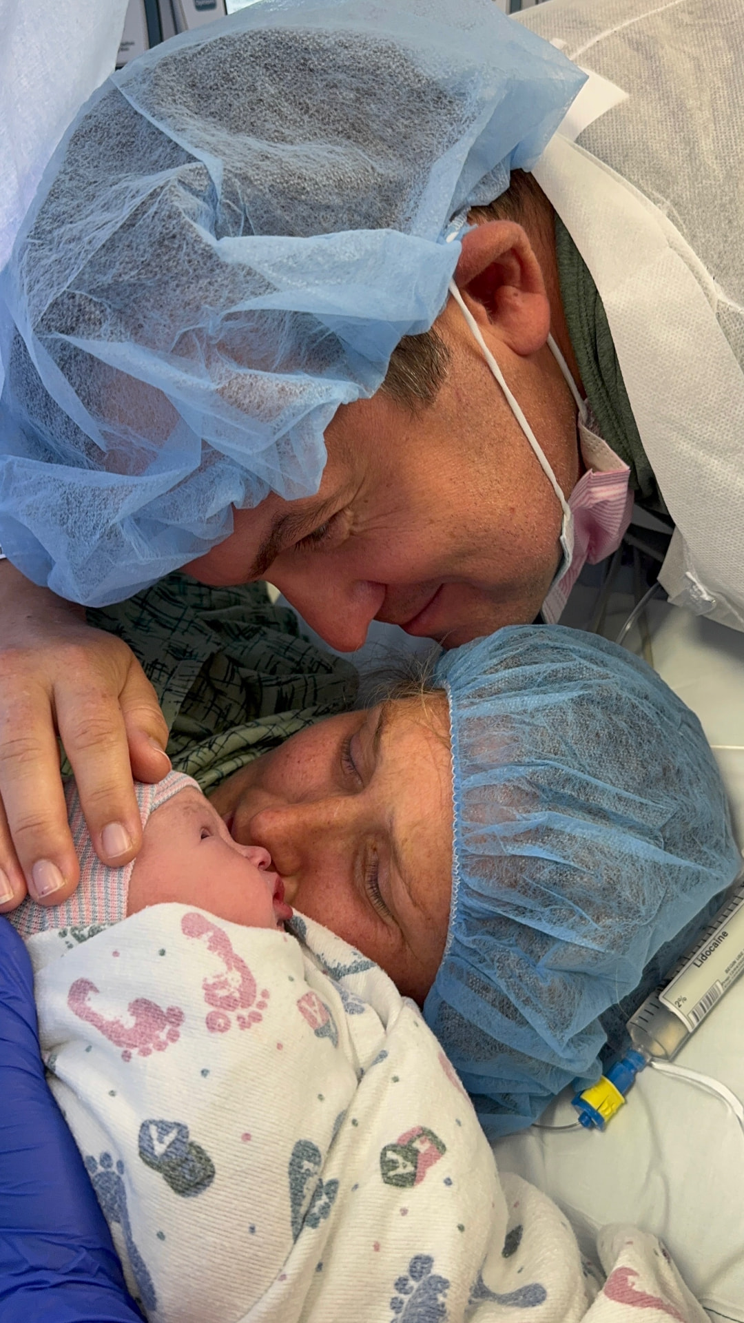 Delaney as a newborn with her parents in the delivery room