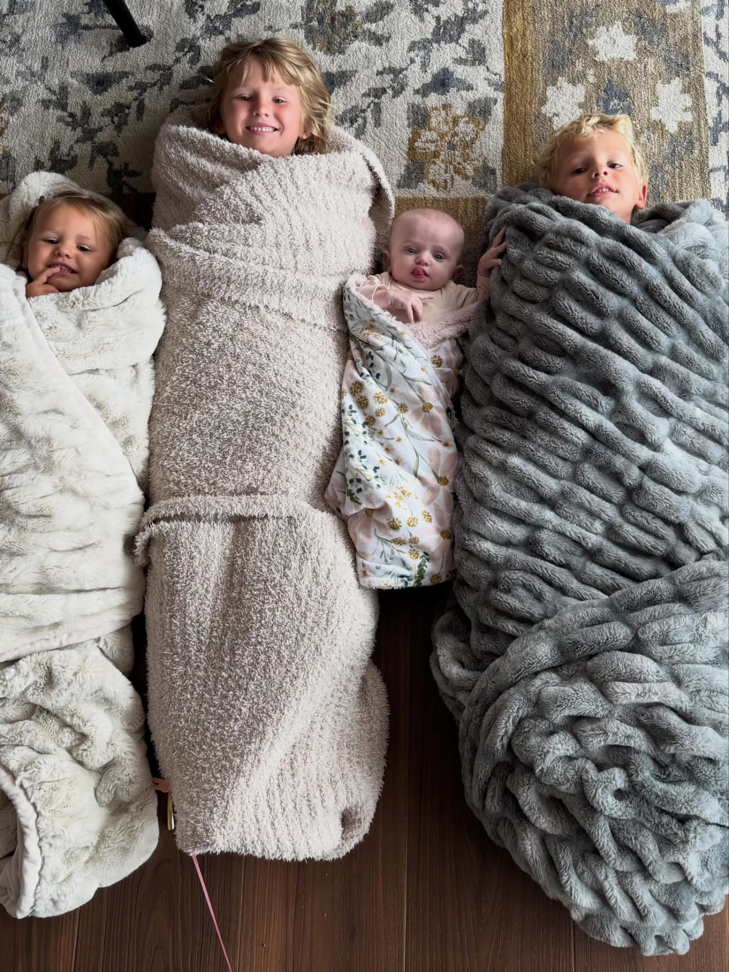 Delaney and her siblings wrapped in blankets